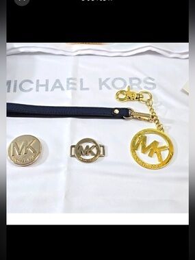 Michael Kors 5pc accessories bundle nwt dust bag. New wristlet strap. Bag charms